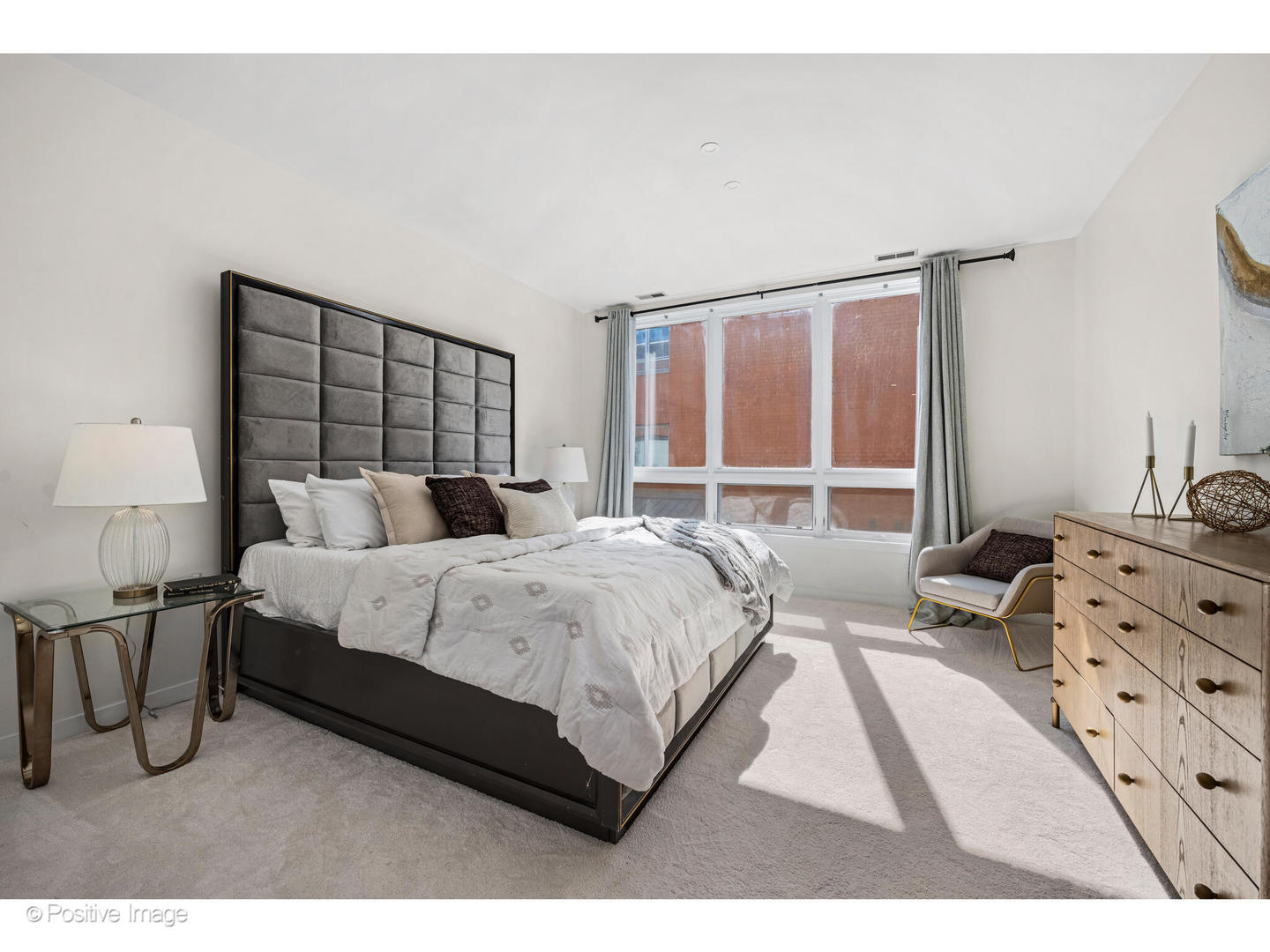 1151 West Washington Boulevard, Unit 136 Chicago, IL 60607 - Photo 11 of 19 a bedroom with a bed and a night stand