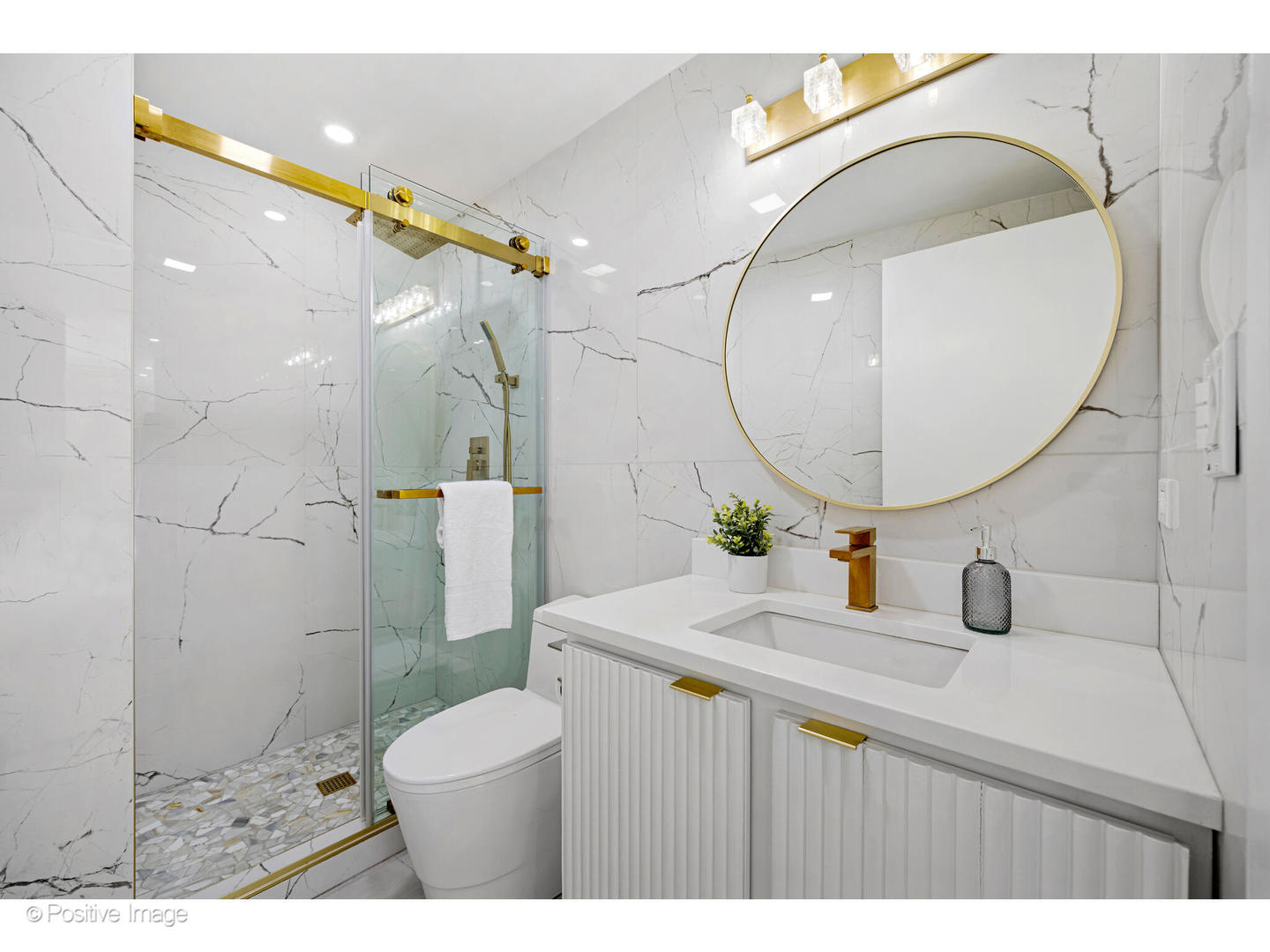 1151 West Washington Boulevard, Unit 136 Chicago, IL 60607 - Photo 15 of 19 a bathroom with a sink a toilet and a mirror