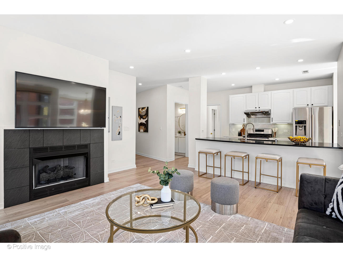 1151 West Washington Boulevard, Unit 136 Chicago, IL 60607 - Photo 6 of 19 a living room with furniture a fireplace and kitchen view