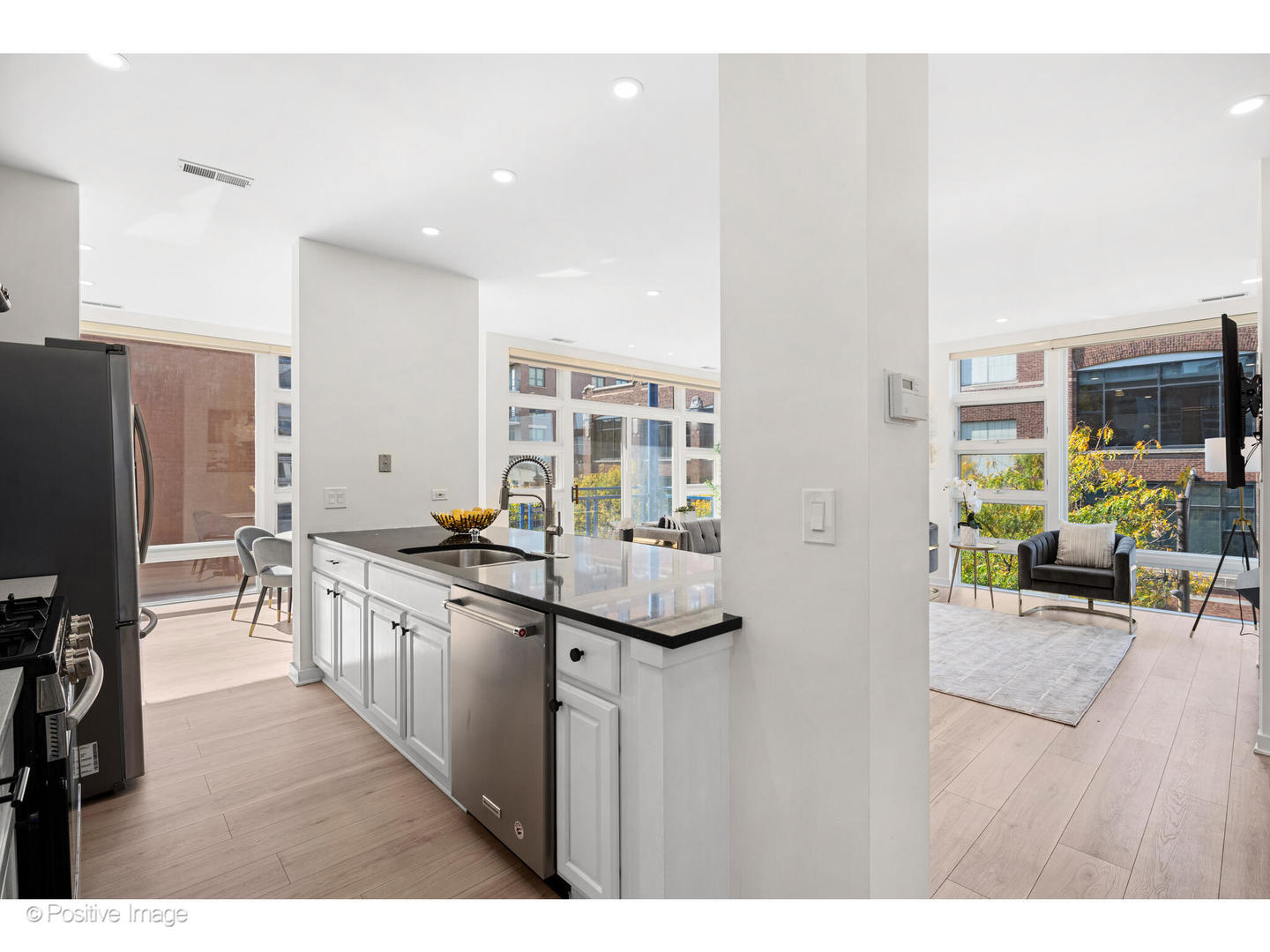 1151 West Washington Boulevard, Unit 136 Chicago, IL 60607 - Photo 8 of 19 a kitchen with stainless steel appliances granite countertop a refrigerator and a stove top oven