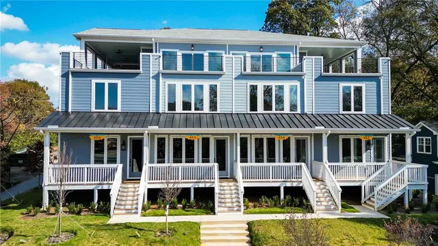a front view of a residential apartment building with a yard