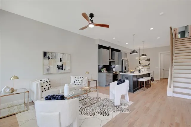 a living room with furniture kitchen view and a piano