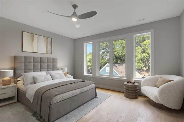 a bedroom with bed and a large window