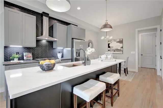 a kitchen with sink cabinets and chairs