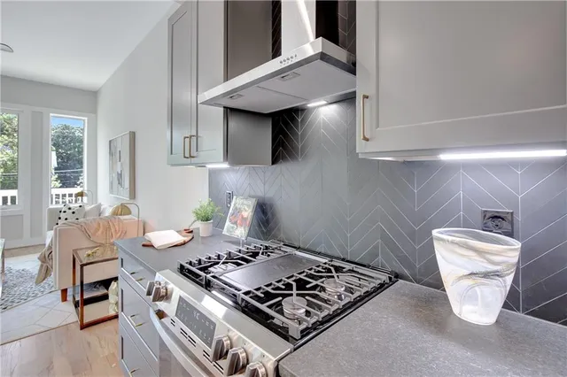 a stove top oven sitting inside of a kitchen