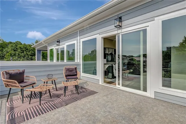 a view of a patio with table and chairs and potted plants