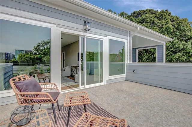 a balcony with furniture and a potted plant