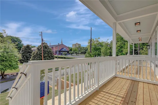 a view of a balcony with wooden floor