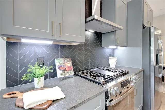 a kitchen with a stove and a refrigerator