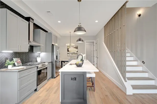 a kitchen with a sink stove and cabinets