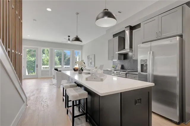 a kitchen with stainless steel appliances a sink stove and refrigerator