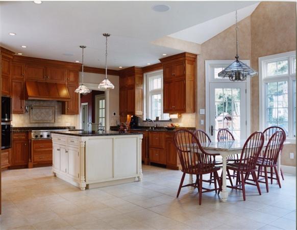 32 Clark Road Andover, MA 01810 - Photo 13 of 28 a kitchen with stainless steel appliances granite countertop a stove a sink a microwave a dining table and chairs