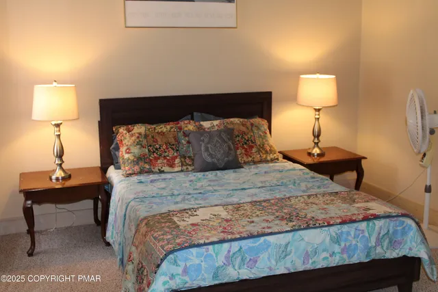 a bedroom with a bed and a lamp on table