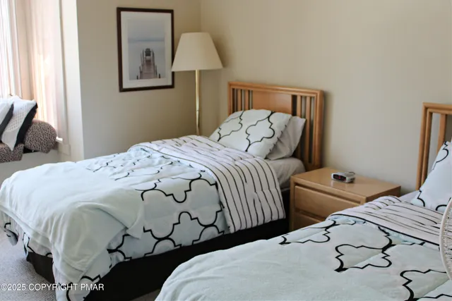 a bedroom with a bed and a lamp