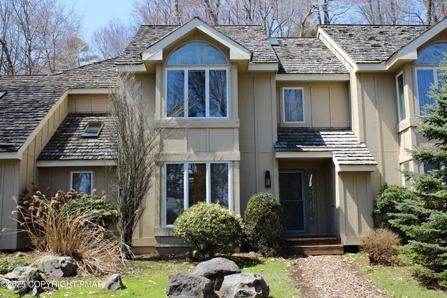 a front view of a house with yard