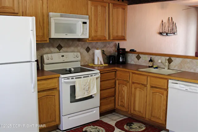 a kitchen with appliances a sink and cabinets