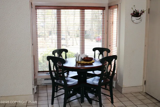a view of a dining room with furniture and window