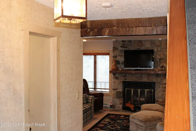 a living room with a fireplace and a flat screen tv