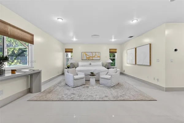 a en suite bathroom with a granite countertop toilet and a sink