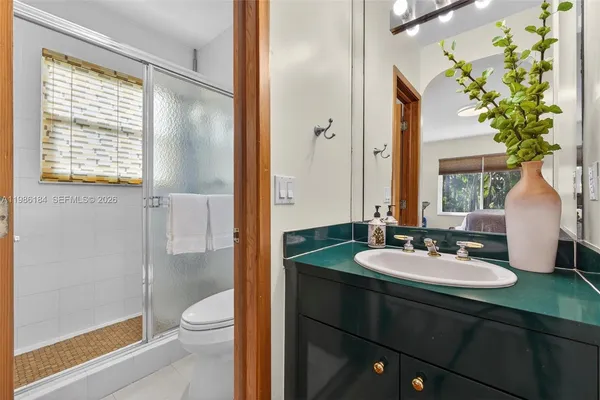 an aerial view of a house with yard and swimming pool