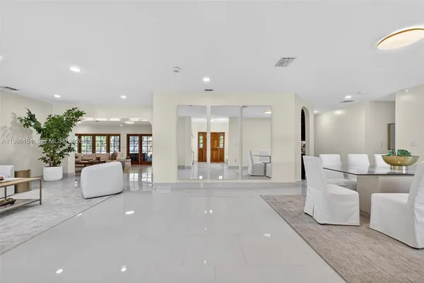 a living room with furniture kitchen view and a table