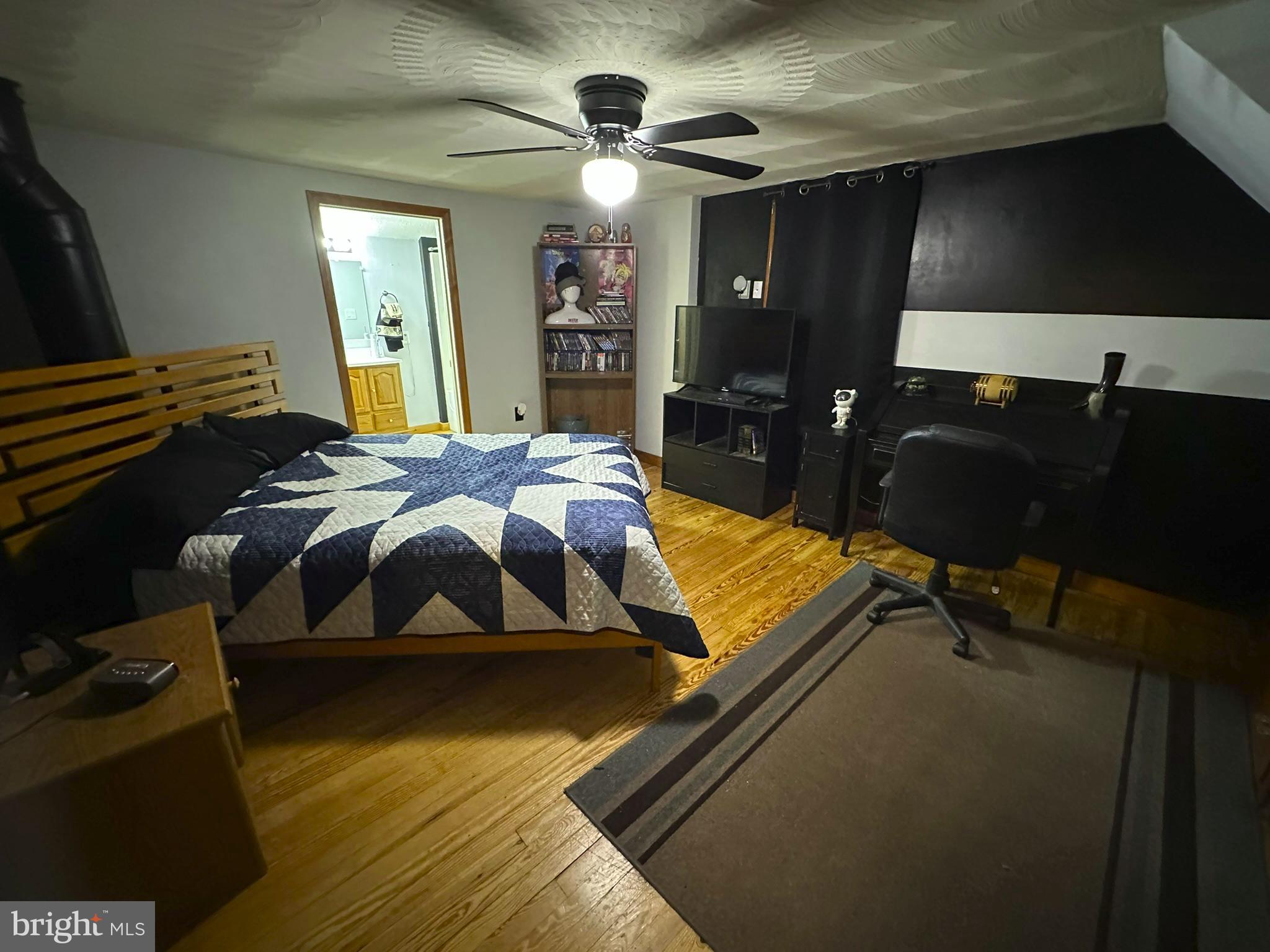 407 Upper Snake Spring Road Everett, PA 15537 - Photo 22 of 58 a bedroom with a bed and lamp