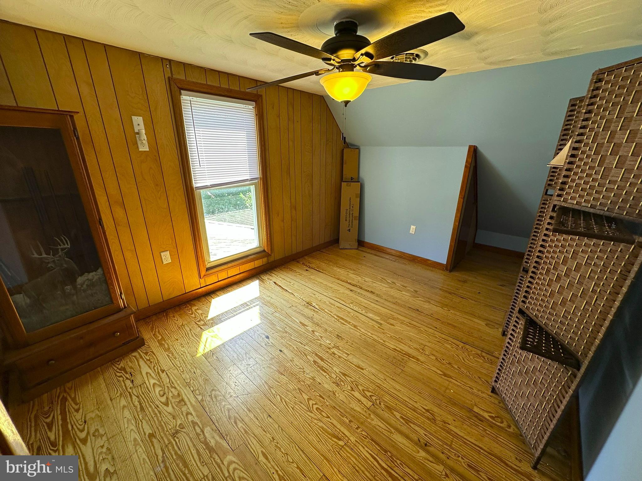 407 Upper Snake Spring Road Everett, PA 15537 - Photo 27 of 58 a view of an empty room with window and wooden floor