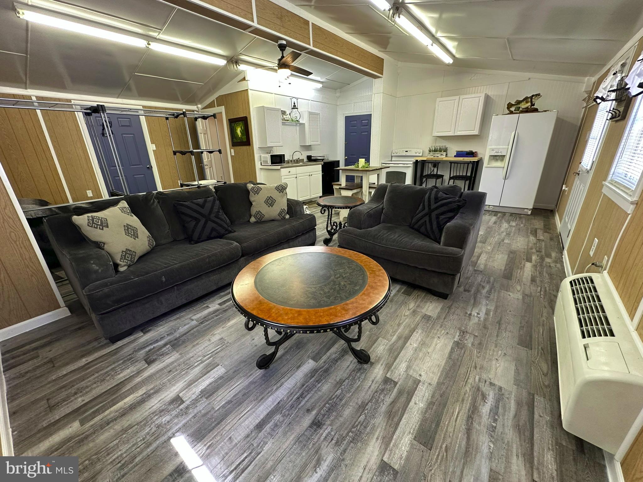 407 Upper Snake Spring Road Everett, PA 15537 - Photo 30 of 58 a living room with furniture and a wooden floor