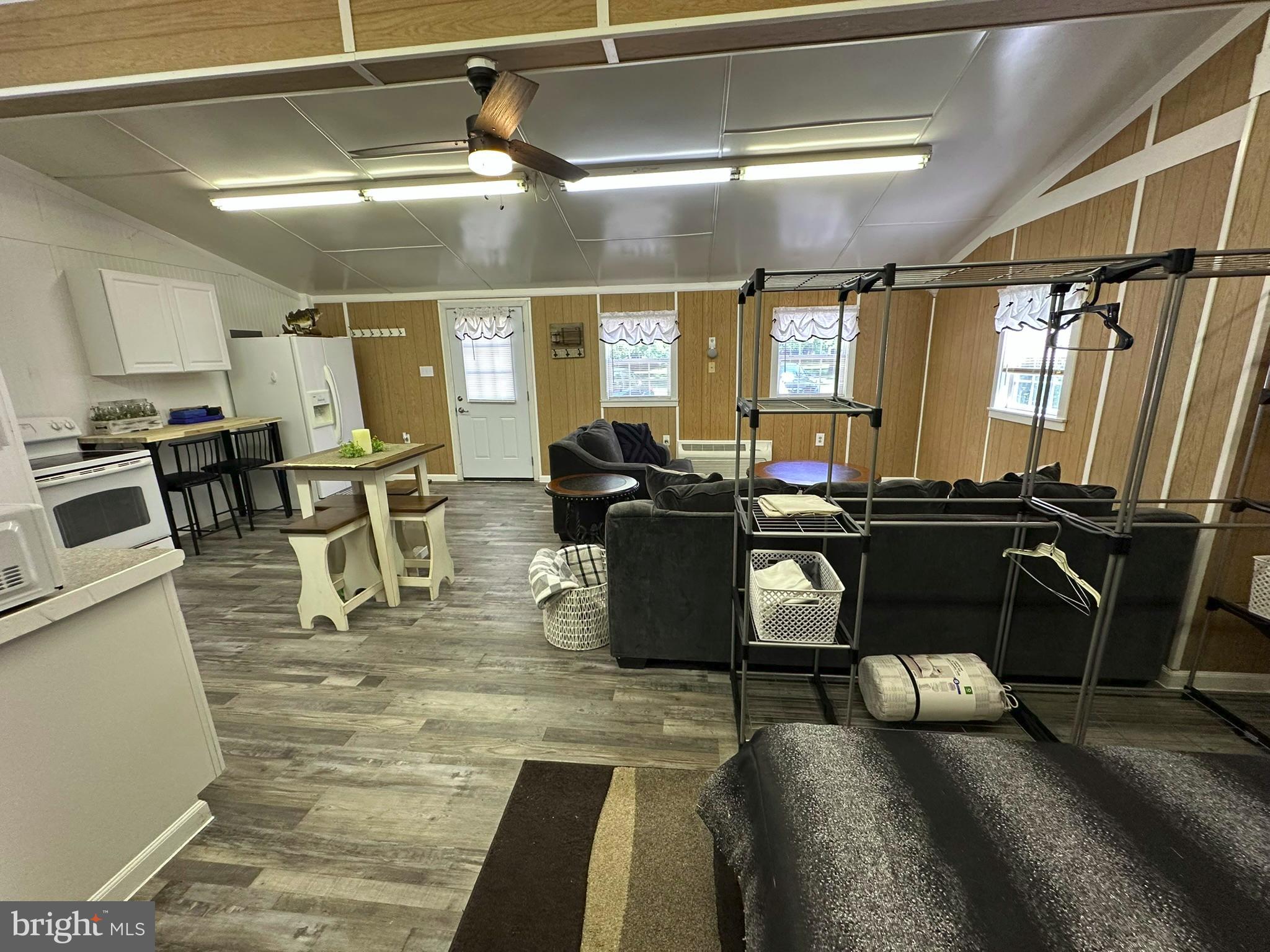 407 Upper Snake Spring Road Everett, PA 15537 - Photo 32 of 58 a living room with lots of chairs and a dining table