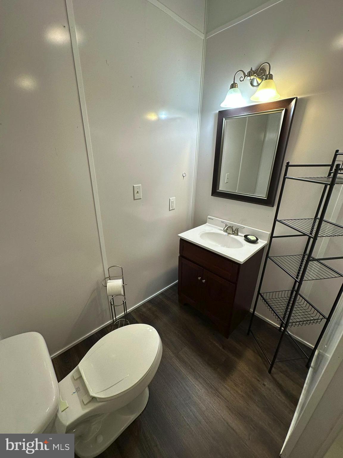 407 Upper Snake Spring Road Everett, PA 15537 - Photo 34 of 58 a bathroom with a toilet a sink and mirror