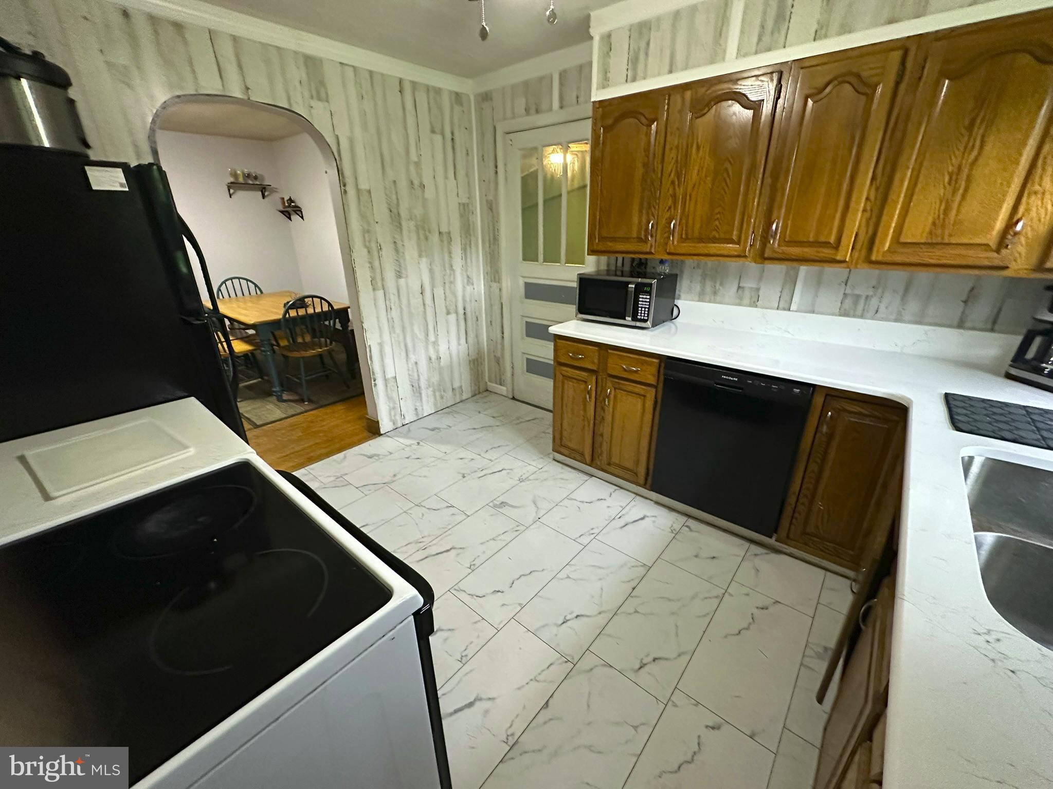 407 Upper Snake Spring Road Everett, PA 15537 - Photo 5 of 58 a kitchen with a sink a stove and cabinets