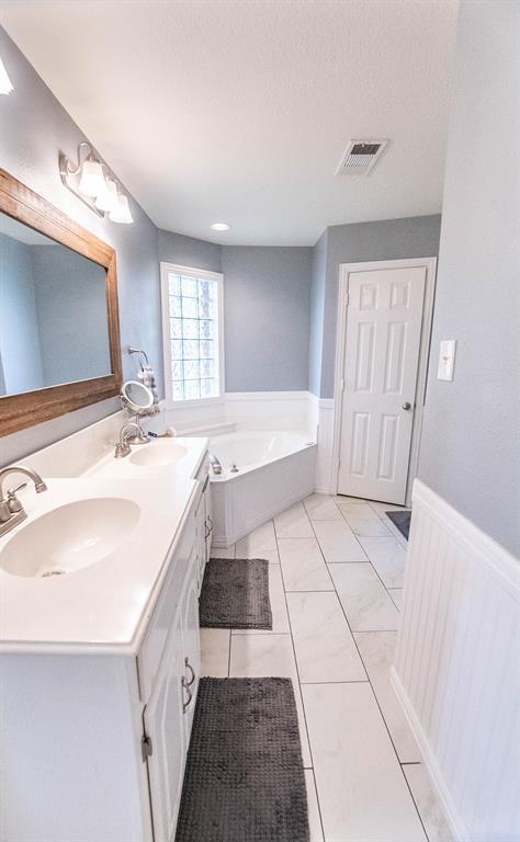 10336 Jennifer Circle Forney, TX 75126 - Photo 19 of 37 The Primary bath offers dual sinks, a deep soaking jetted tub, and nicely remodeled separate shower. This is a spacious, well appointed room.