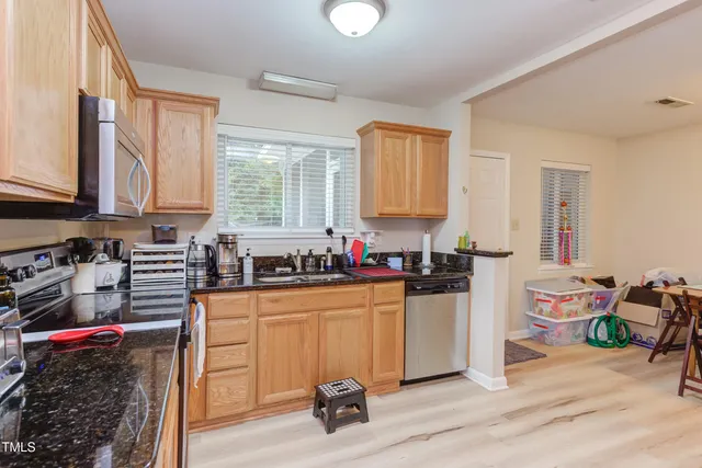 a kitchen with a stove a sink and a refrigerator
