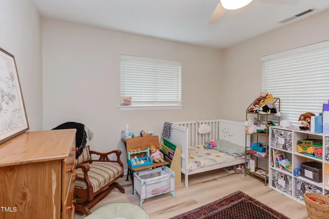 a bedroom with furniture and a book shelf