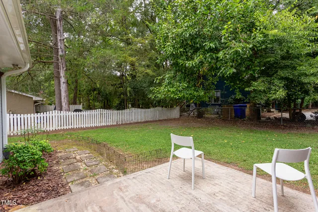 a view of a chair and table in the garden
