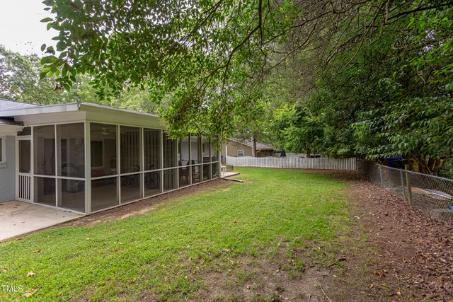a view of a backyard with a large tree