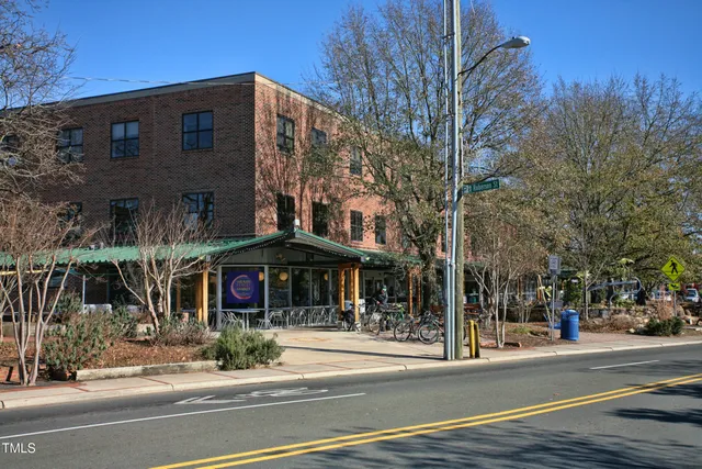 a view of a brick building next to a road