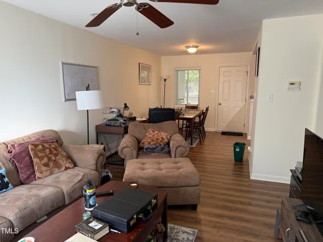 a living room with furniture and wooden floor