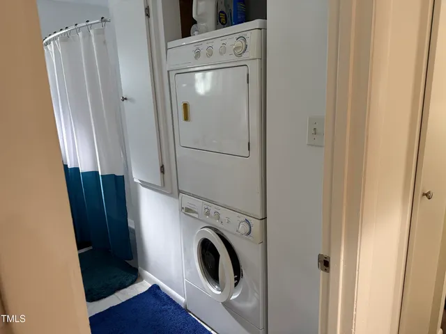 a view of washer and dryer with wooden floor