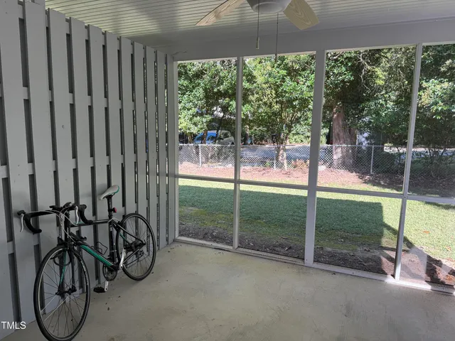 a view of a backyard with table and chairs