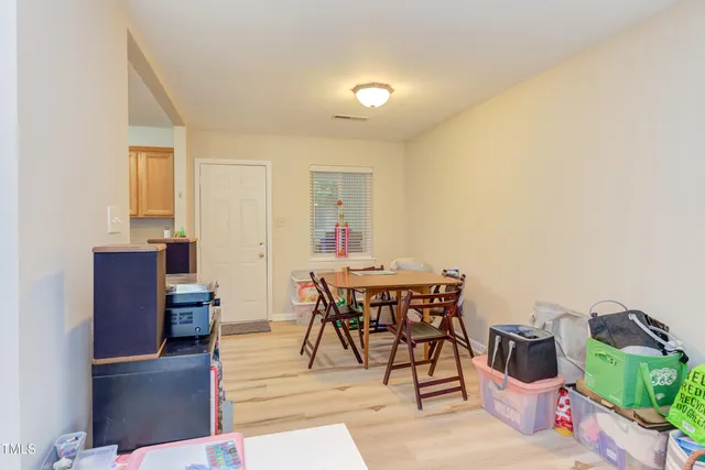 a dining room with furniture and wooden floor