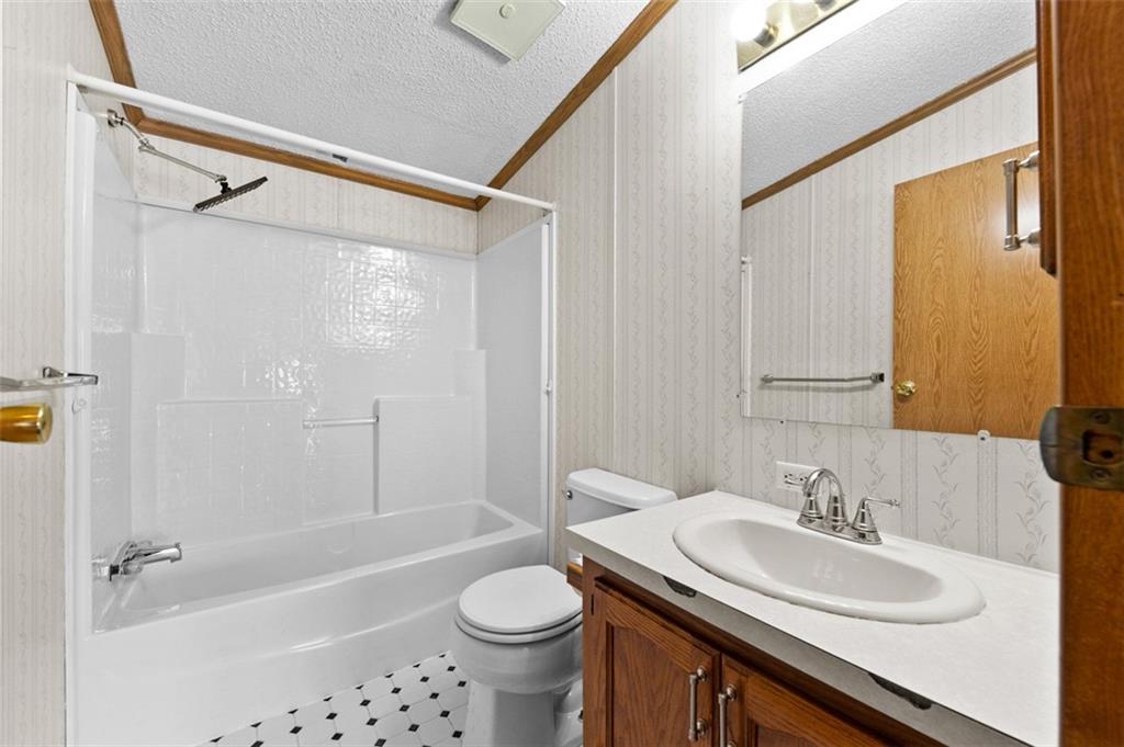 107 Indigo Road Mount Pleasant, PA 15666 - Photo 21 of 36 a bathroom with a sink a toilet a mirror and a shower