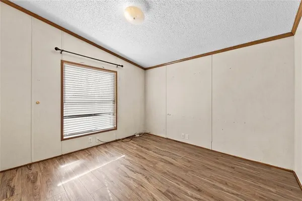 a view of a a dining room with furniture window and wooden floor