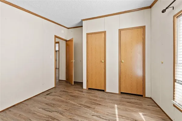 a view of a a dining room with furniture window and wooden floor