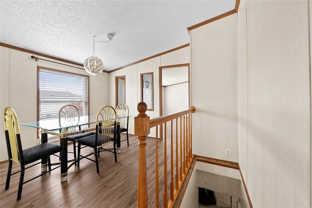 107 Indigo Road Mount Pleasant, PA 15666 - Photo 25 of 36 a view of a a dining room with furniture window and wooden floor