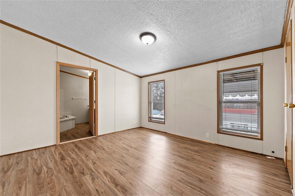 107 Indigo Road Mount Pleasant, PA 15666 - Photo 29 of 36 an empty room with wooden floor and windows