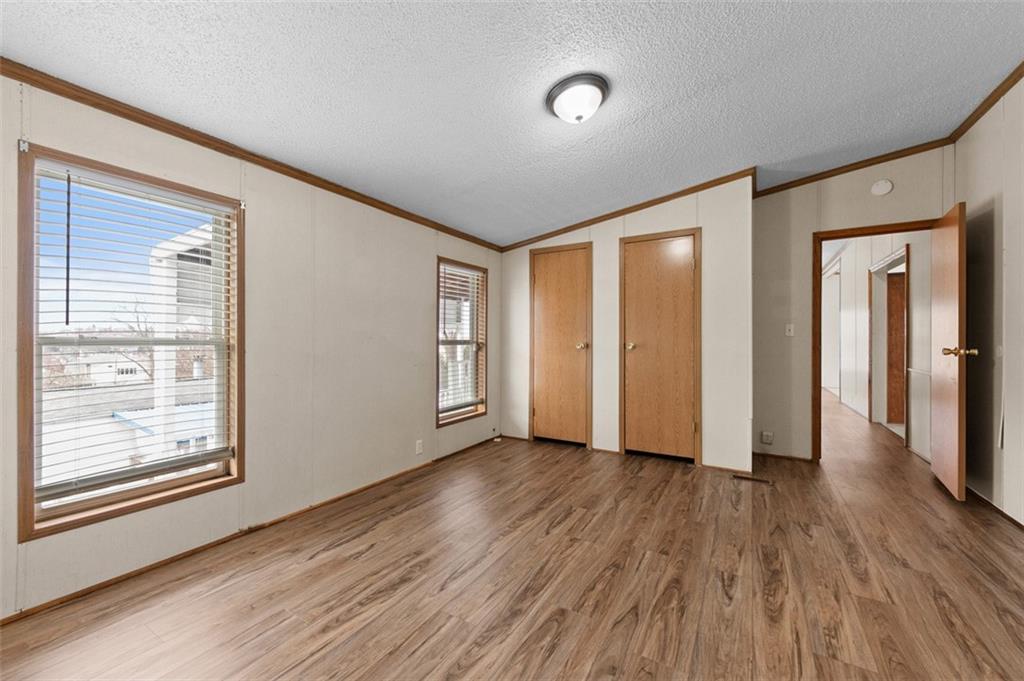 107 Indigo Road Mount Pleasant, PA 15666 - Photo 30 of 36 an empty room with wooden floor and windows