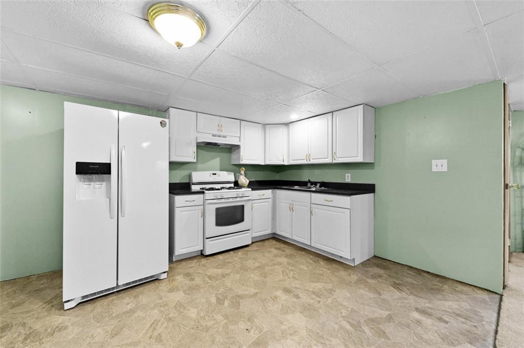 107 Indigo Road Mount Pleasant, PA 15666 - Photo 33 of 36 a kitchen with granite countertop white cabinets and white appliances