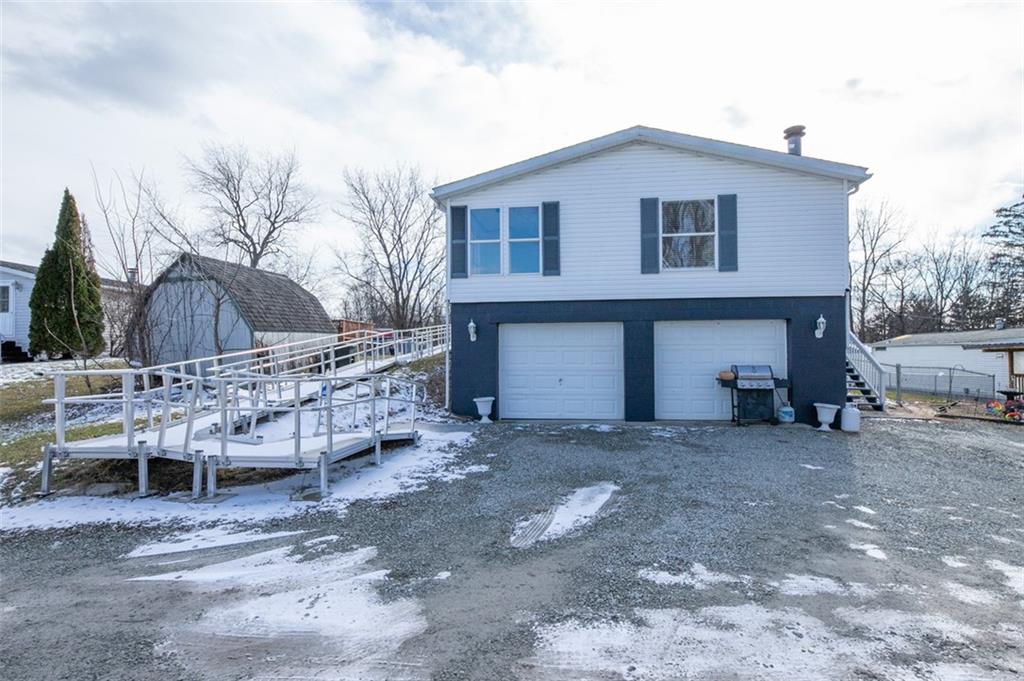 107 Indigo Road Mount Pleasant, PA 15666 - Photo 6 of 36 a front view of a house with a yard and garage