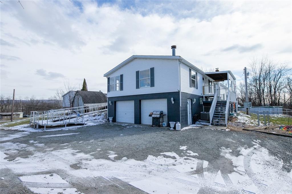 107 Indigo Road Mount Pleasant, PA 15666 - Photo 7 of 36 a view of a house with a big yard and large trees